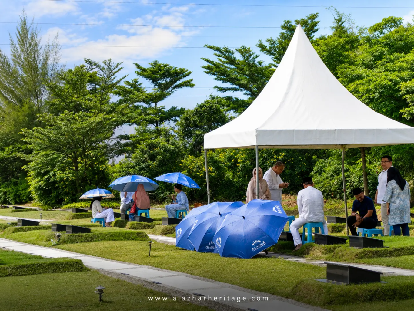 Keluarga berziarah dengan tenda dan kursi di Al Azhar Memorial Garden